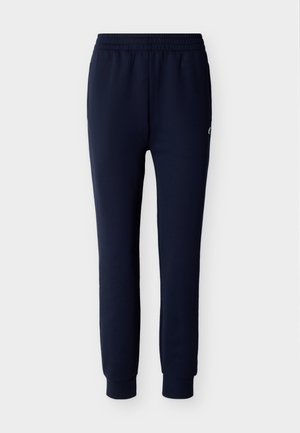 Pantaloni jogger blu navy con vita elastica e caviglie risvoltate, con un piccolo logo sulla coscia sinistra.