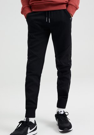MET TAPEDETAILS - Tracksuit bottoms - black