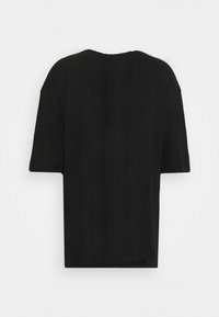 Black, short-sleeved t-shirt with a loose fit. Simple, matte texture; crew neckline; no visible branding or embellishments.