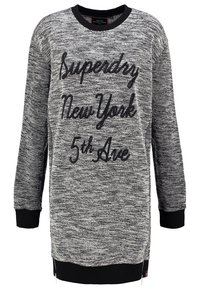 Grauer Strick-Pullover mit schwarzen Akzenten. Verfügt über fetten schwarzen Text, der "Superdry New York 5th Ave" liest, und Reißverschlüsse an den Seitensäumen.