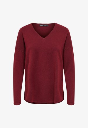 Burgundy long-sleeve top with a V-neck, soft texture, relaxed fit, and a slightly rounded hem. Tag visible at the neckline.