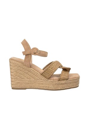 Beige wedge sandals with a woven jute heel, suede straps, and ankle buckle. Features cross-over design on the front. Soft texture.