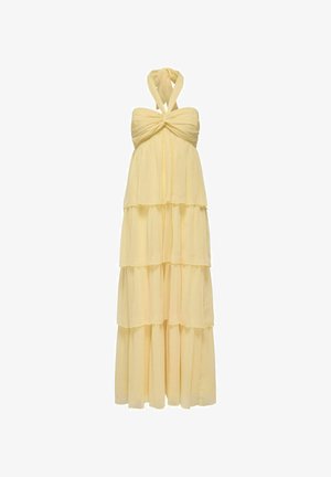 Žuta halter haljina s višeslojnim dizajnom, izrađena od laganog materijala s čvorastim korzetom i suknjom s slojevima.
