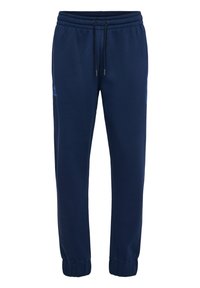 Marinblå joggerbyxor tillverkade av mjukt tyg, med elastisk midja och snörningar samt ribbade cuffs vid anklarna.
