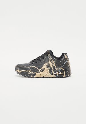 Black athletic sneaker with beige marble pattern, air cushion sole, lace-up closure, and low-top design on a white background.