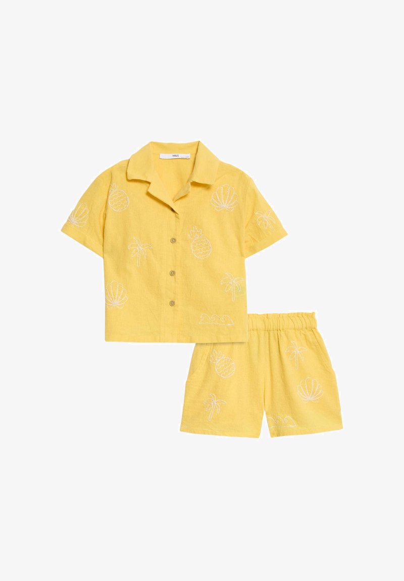 Yellow linen two-piece set featuring a collared short-sleeve shirt with embroidered pineapple and palm motifs and matching elastic waistband shorts.