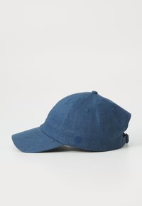 Dark blue cap made of textured fabric, featuring a curved brim, adjustable strap, and embroidered logo on the side.