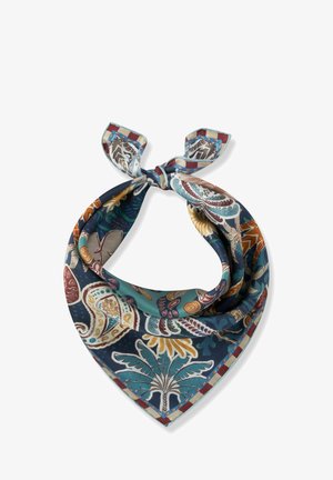 Écharpe en soie avec un motif vibrant de feuilles tropicales et de paisley en bleu, bleu sarcelle, marron et beige, nouée en un nœud lâche.