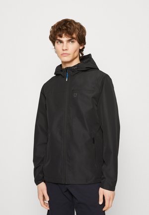 Zwarte hoodie gemaakt van lichtgewicht materiaal, met een volledige ritssluiting aan de voorkant, ritszakken aan de zijkanten en minimale branding op de borst.