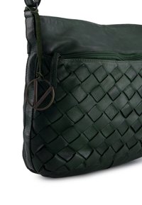 Dark green leather shoulder bag with a woven texture, zippered pocket, and a round metal accent tag keychain.