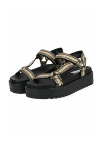 Sandali platform neri con cinghie incrociate regolabili realizzate in tessuto a fantasia beige e nera. Presentano una suola in gomma testurizzata per una maggiore aderenza.