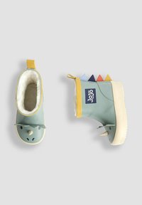 Zelené gumové čižmy so žltými akcentmi, plyšovým vnútorným podšívkom, hrebienkovými ostňami v modrej, červenej a námorníckej farbe a dizajnom inšpirovaným dinosaurami.