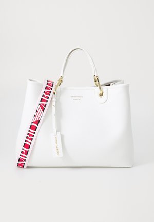 White tote bag with gold hardware, featuring a colorful strap labeled "Emporio Armani" and a tag, against a plain background.