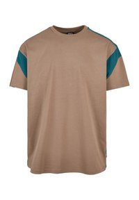 Helles Baumwoll-T-Shirt mit entspanntem Schnitt, kurzen Ärmeln und kontrastierenden türkisfarbenen Akzenten an den Schultern. Keine auffälligen Muster oder Hardware.
