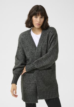 Dark grey knitted cardigan with a V-neck, ribbed cuffs and hem, front pockets, and a relaxed fit featuring a side slit.