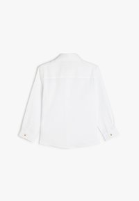 Witte longsleeve shirt gemaakt van lichtgewicht stof. Heeft een klassieke kraag, knoopmanchetten en een licht gebogen zoom.