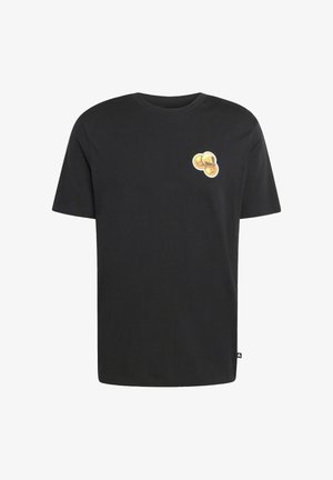 Camiseta de algodón negra con un gráfico de tres monedas doradas en el lado izquierdo del pecho. Manga corta y diseño de cuello redondo.