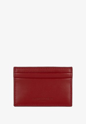 Red leather cardholder featuring four slots, embossed logo, and smooth texture. Compact, with rounded edges and neat stitching.