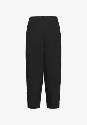 Mustad lahtised püksid elastse vöökohaga ja peene tikandiga välisääre õmblustel.