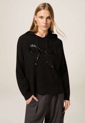 Schwarzer Kapuzenpullover aus weichem Stoff mit einem großen Paillettenbogen-Design auf der Vorderseite, mit Kordelzügen und einer lässigen Passform.