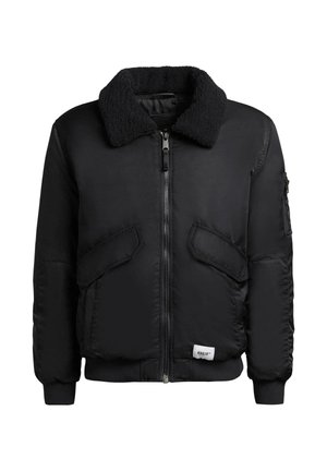 Veste bomber noire avec un col en shearling noir doux, fermeture zippée à l'avant et deux grandes poches avant. Poignets et ourlet côtelés.