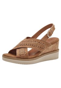 Sandalo con zeppa color tan, caratterizzato da tomaia in suede intrecciato, punta aperta, cinturino alla caviglia con fibbia regolabile e zeppa con texture in sughero.
