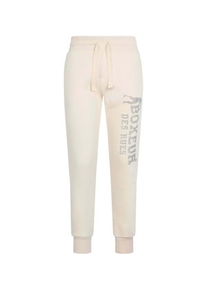 Pantaloni della tuta color crema con polsini e vita elastici, caratterizzati da un logo stampato argento lungo la gamba sinistra e un tessuto morbido e strutturato.