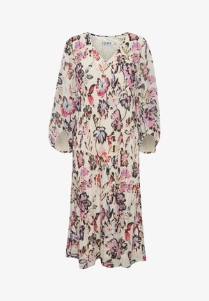 Abito floreale con scollo a V, maniche lunghe a sbuffo e gonna plissettata. Presenta uno sfondo crema con fiori multicolore e dettagli di foglie.