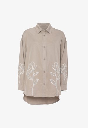Camicia beige con bottoni, colletto, maniche lunghe e ricamo bianco a disegno floreale sulla parte anteriore inferiore e sulle maniche.