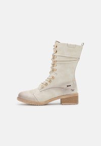 Lace-up ankle boots in light beige leather with gold-tone eyelets, a block heel, and a small silhouette of a horse on the side.
