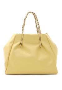 Żółta skórzana torebka z plecionymi beżowymi uchwytami, dużym kształtem, miękką teksturą i marszczonymi bokami. Minimalistyczny design bez widocznych elementów metalowych.