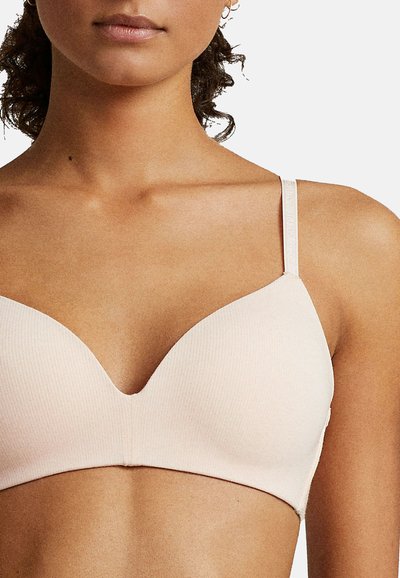 Ljust rosa ribbad BH med djup halsringning och tunna justerbara band. Har en slät yta och en enkel design med minimalt med hårdvara.