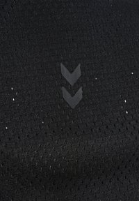 Black textured fabric featuring small perforations, with a discrete black logo of two downward-facing chevrons.