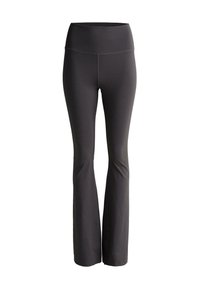 Pantalons de yoga noirs évasés avec une taille haute, fabriqués dans un matériau extensible. Texture lisse avec des détails de couture subtils.