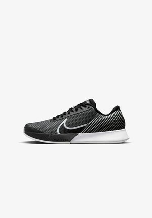Scarpe atletiche nere e grigie con parte superiore in rete, caratterizzate da un prominente logo Nike bianco e dettagli a strisce sul tallone. Soletta in schiuma.