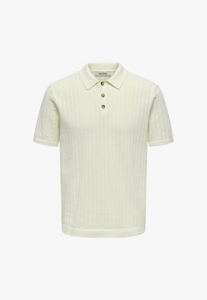 Kremfarget kortermet strikket poloshirt med teksturert mønster og tre brune knapper på placket, krage og oppbrettede ermer.