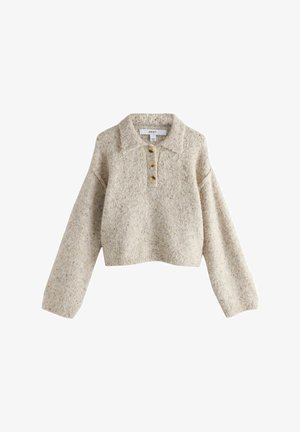 Béžový pletený skrátený sveter s golierom, dlhými rukávmi a tromi veľkými hnedými gombíkmi na prednej lište.