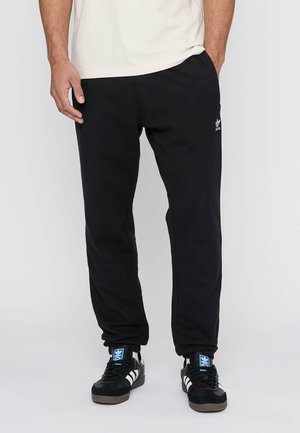 Zwarte sweatpants gemaakt van katoenmix stof, met een elastische tailleband, taps toelopende pasvorm en een wit logo detail op de linkerheup.