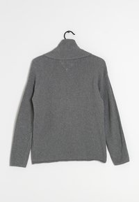 Gray knitted sweater with a high collar, featuring ribbed texture and long sleeves. Hem is straight with a slightly loose fit.