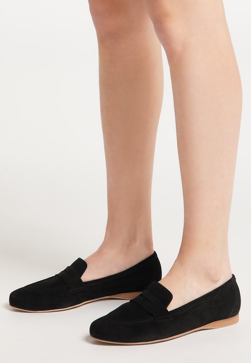 Loafers negri din suede cu talpă plată, având o brățară decorativă pe partea superioară și un finisaj neted. Design ușor și minimalist.