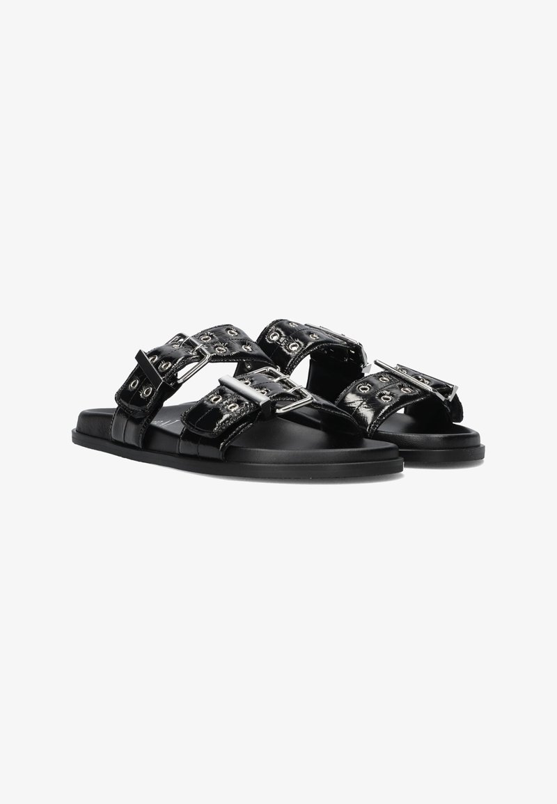 Black patent leather sandals with two wide straps featuring silver hardware and decorative eyelets. Flat sole and sleek design.