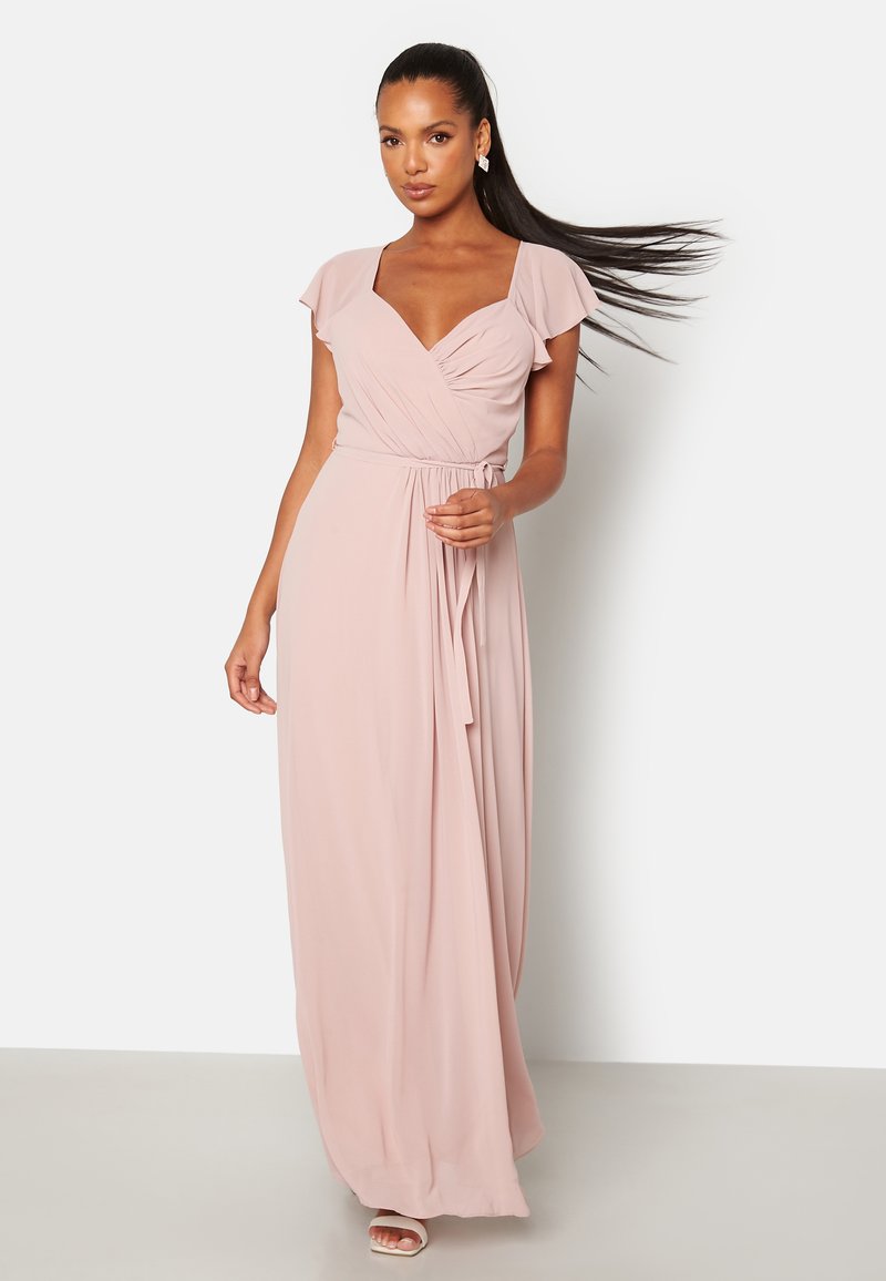 Maxi-jurk in zachtroze stof met korte vlindermouwen, diepe V-hals, gedrapeerde taille en vloeiende rok. Fluweelachtige textuur.