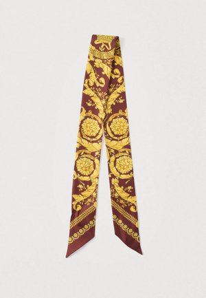Silk scarf featuring a rich burgundy background with intricate yellow floral and ornate patterns, finished with a decorative border.