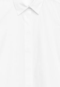 White button-up shirt featuring a classic collar and a smooth, woven texture with a front placket; no visible patterns or accents.