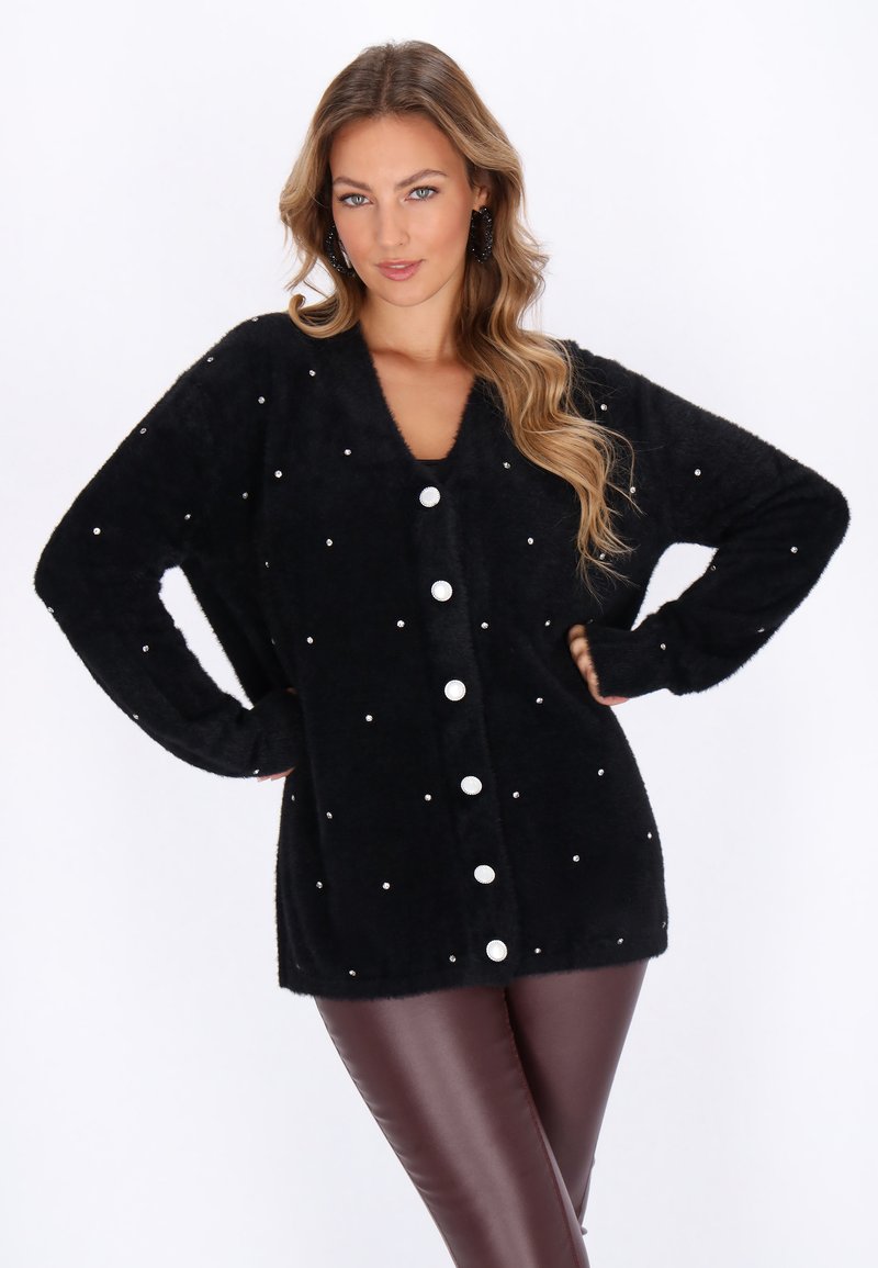 Black fuzzy cardigan featuring a V-neckline, decorative pearl-like accents, and large white buttons down the front. Soft texture.
