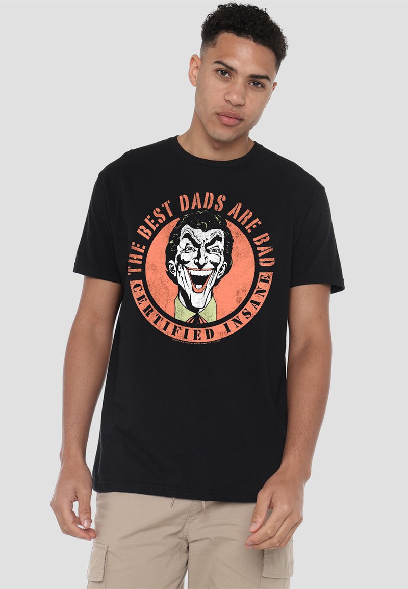 Black cotton t-shirt featuring a colorful graphic of a smiling clown with the text "THE BEST DADS ARE BAD CERTIFIED INSANE" in orange and white.