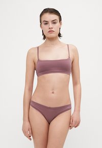 Mauve colored bralette and matching bikini-style underwear made of soft fabric. The bralette has thin straps and a seamless design.