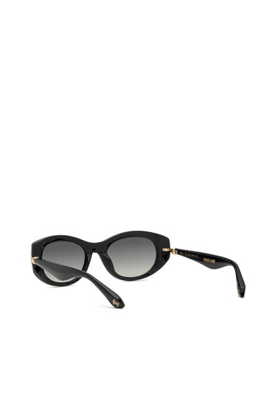Lunettes de soleil noires style cat-eye avec verres dégradés et charnières dorées, présentées légèrement inclinées sur un fond blanc.