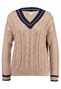 Maglione beige a coste con colletto a V navy e righe navy sui polsini, caratterizzato da maniche lunghe e orlo a coste.