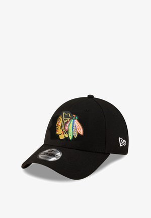 Black cap with a rounded visor. Features an embroidered logo with a Native American design in vibrant colors. Made from fabric with a smooth texture.